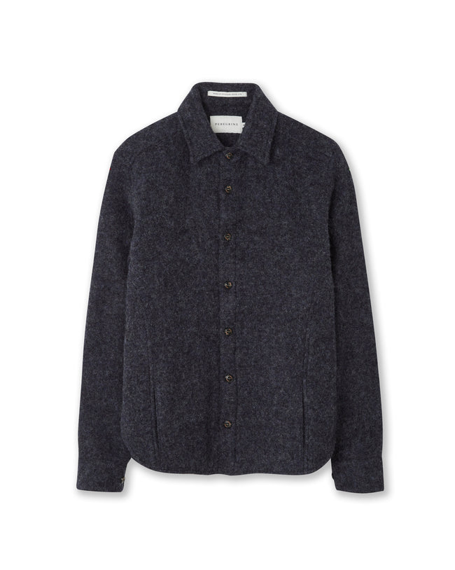 Flatlay image of navy wool collared shirt with seven small black buttons fastening down the center front fastening the shirt closed, the shirt has two discreet pockets on the either front bottom side of the shirt.